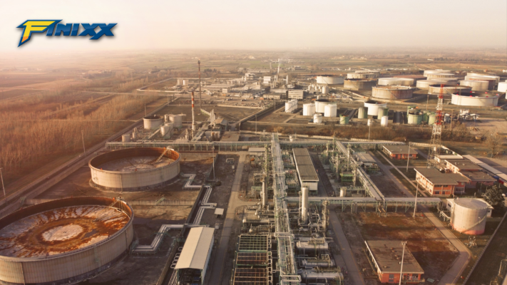 Drone view of a large industrial oil refinery with storage tanks and processing equipment