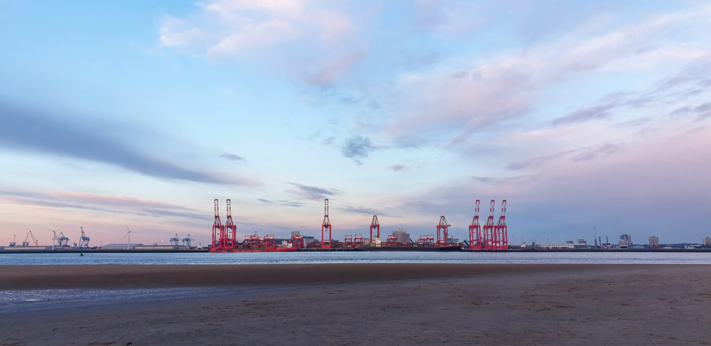 View of the sea port of Liverpool at sunset, cranes for loading